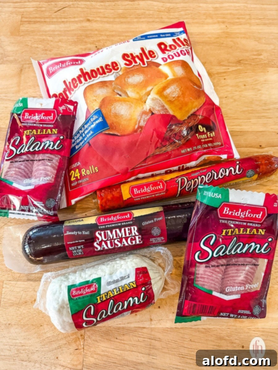 Effortless Charcuterie Boards 4 A selection of Bridgford Foods products including Parkerhouse rolls, salami, pepperoni, and summer sausage, ready for charcuterie board preparation.