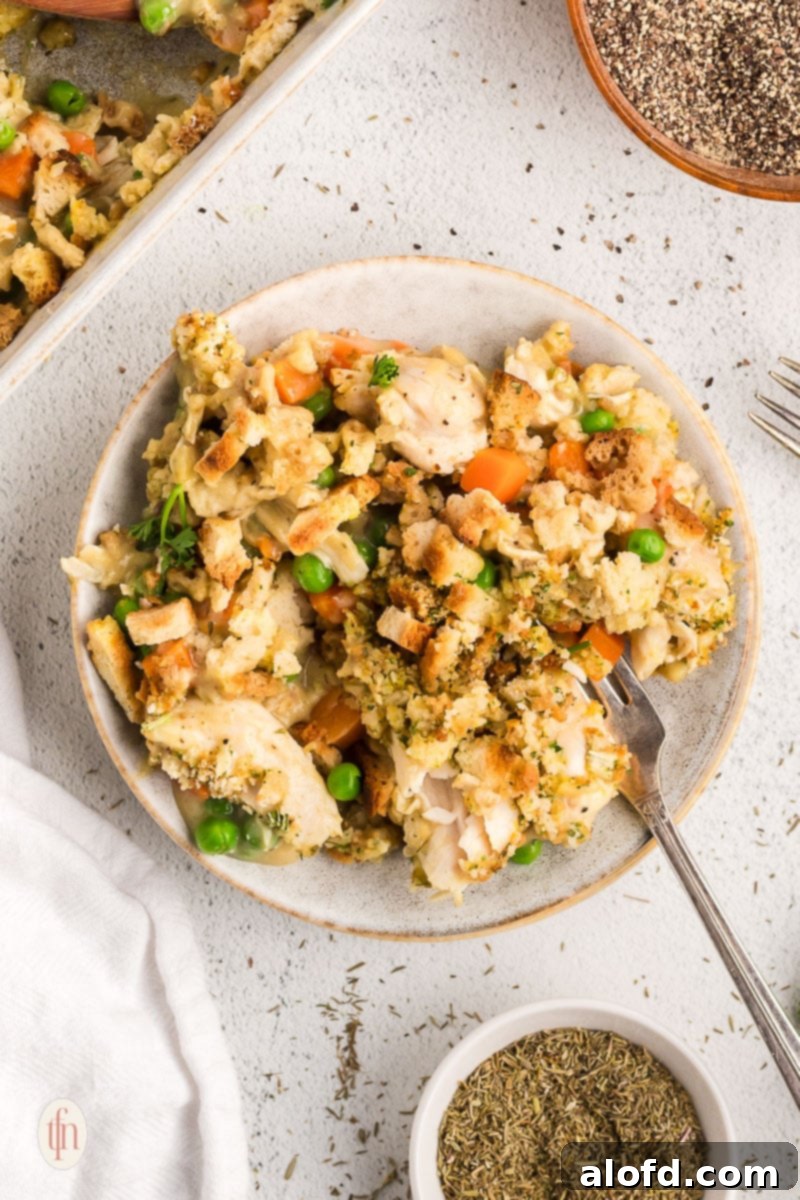 Reinventing Your Thanksgiving Turkey 3 A golden-brown leftover turkey stuffing casserole on a white plate, ready to be served.