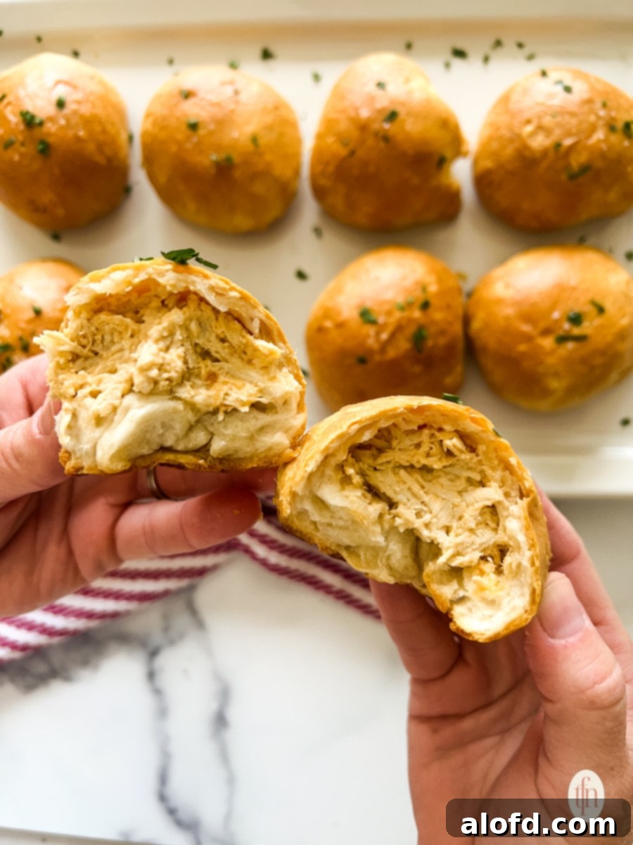 Reinventing Your Thanksgiving Turkey 4 Hands separating a golden-baked turkey leftover bomb into two halves over a baking tray.