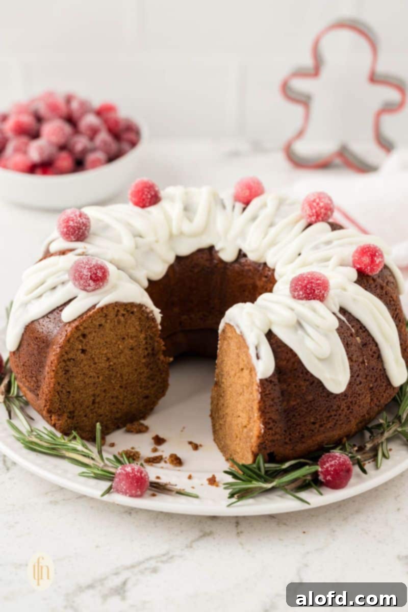 Spiced Molasses Bundt Cake 12 A whole gingerbread bundt cake, elegantly covered in a vanilla glaze, resting on a white plate, symbolizing holiday perfection.