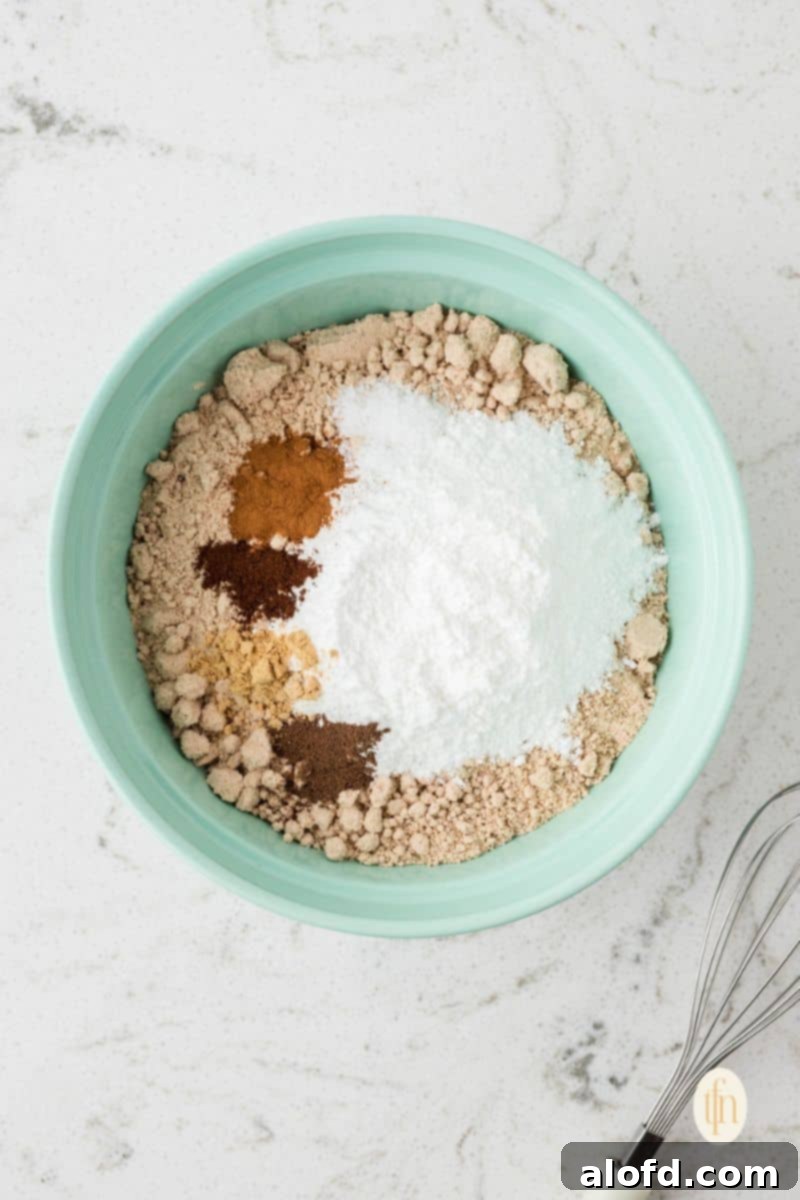 Spiced Molasses Bundt Cake 7 Mixed cake batter in a vibrant green mixing bowl, showcasing a smooth and consistent texture, ready for the next baking step.