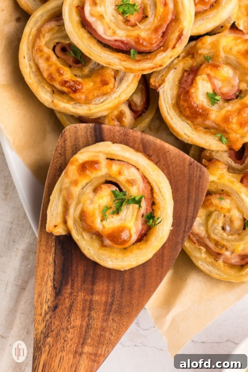 finger food ideas showing ham and cheese pinwheels on serving platter 