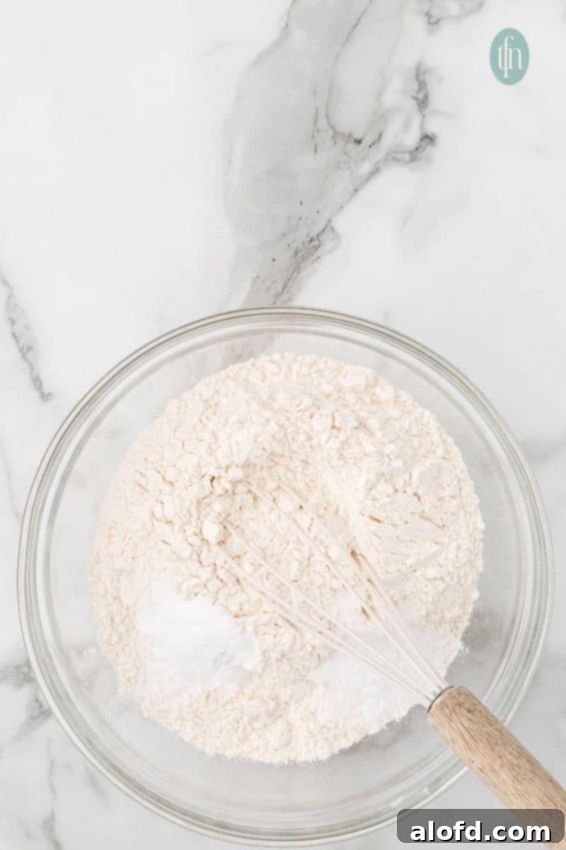 Artisan Sourdough Chocolate Chip Cookies 12 Dry ingredients in a glass bowl with whisk.