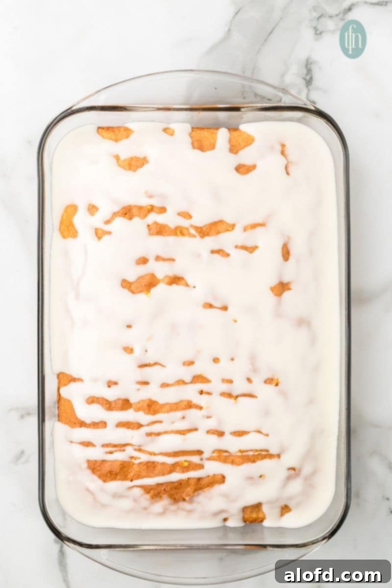 A glass pan of cake with glaze.