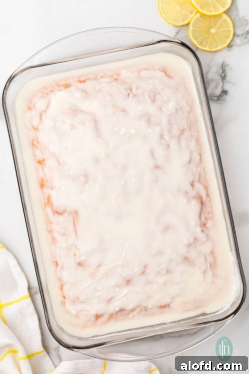 A glass pan of cake with glaze.