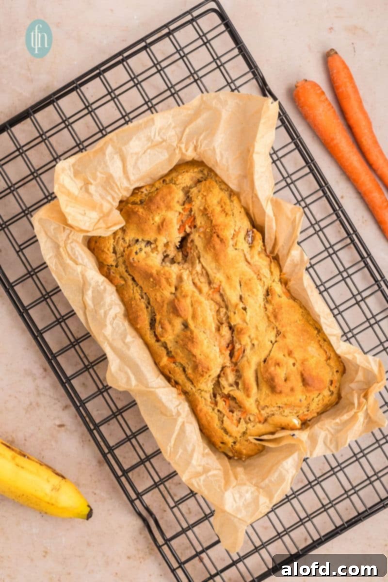 Farmhouse Carrot Cake Loaf 18 Baked loaf in a pan with parchement paper.