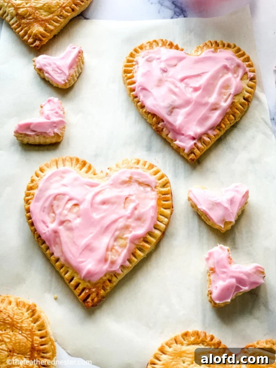 A close-up of homemade pop tarts, charmingly shaped like hearts and decorated for Valentine's Day, ready to be enjoyed.