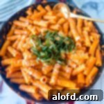 March Flavor Feast: Irresistible Dinner Ideas 23 Close-up of rigatoni alla vodka, richly coated in sauce, served in a rustic cast iron skillet.