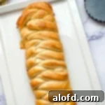 March Flavor Feast: Irresistible Dinner Ideas 34 An elegant lemon braided bread loaf, beautifully presented on a white platter, inviting you to enjoy its sweet and tangy flavors.