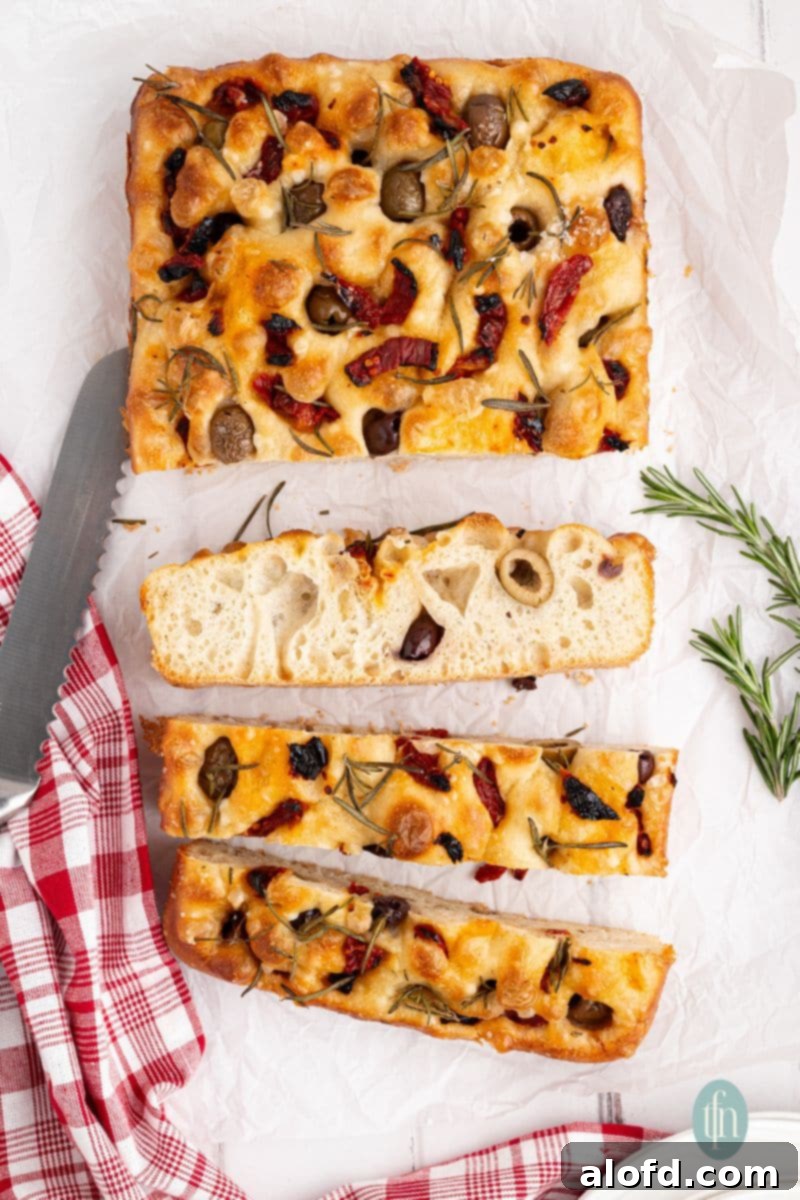 Several slices of perfectly baked sourdough focaccia bread, ready to be enjoyed.