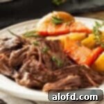 Platter full of chuck pot roast with carrots and potatoes, ready to be served.