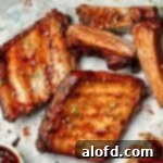 Baby back pork ribs slathered in BBQ sauce, cooked to perfection.