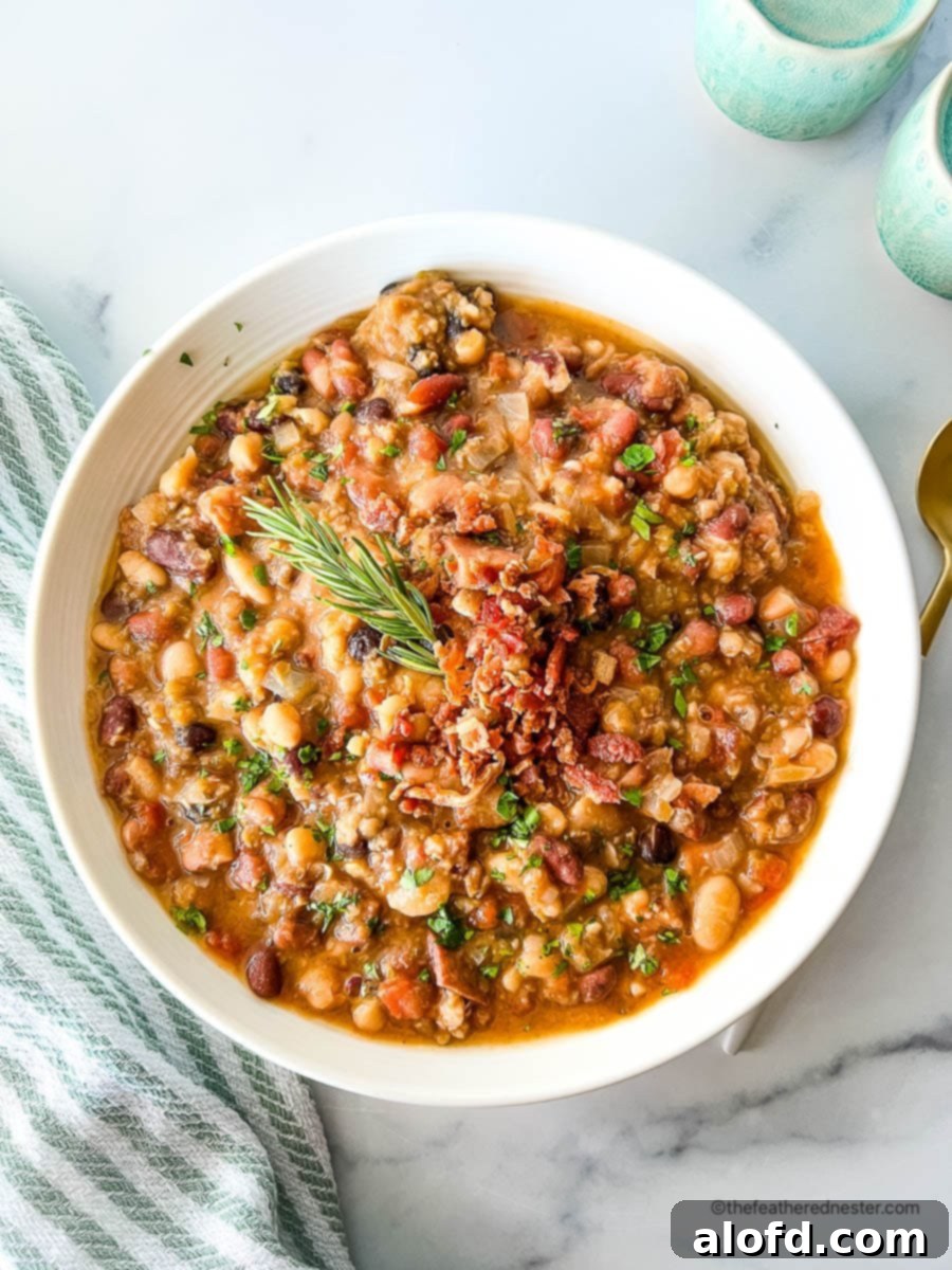 Slow cooker 15 bean soup on a white bowl, showcasing flavorful crockpot beans.