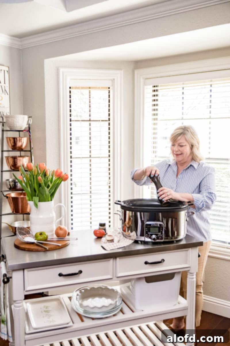 A woman cooking a meal with a slow cooker, illustrating the ease of making delicious slow cooker recipes.