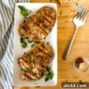 Succulent Buttermilk Pork Chops 12 Platter with two tender and juicy buttermilk pork chops, garnished.