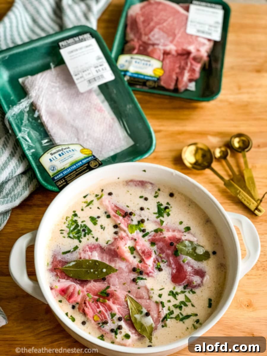 Succulent Buttermilk Pork Chops 6 A shallow bowl showing pork chops soaking in a flavorful buttermilk brine.