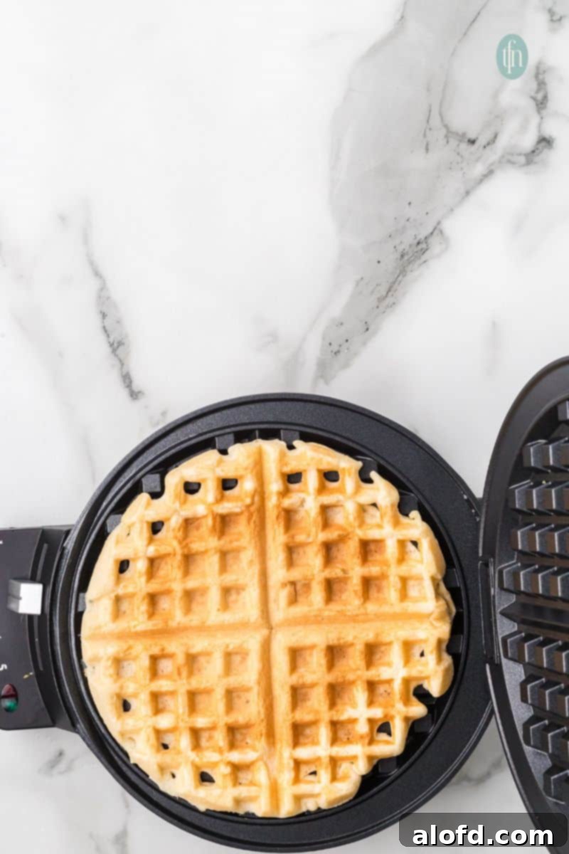 Fluffy Golden Bisquick Waffles 13 Cooked waffles on a waffle maker.