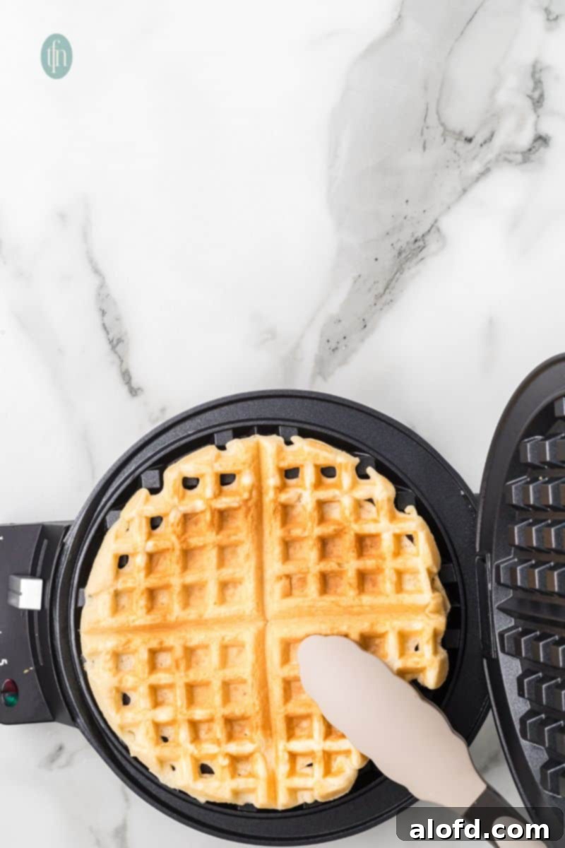 Fluffy Golden Bisquick Waffles 14 Cooked waffles on a waffle maker.