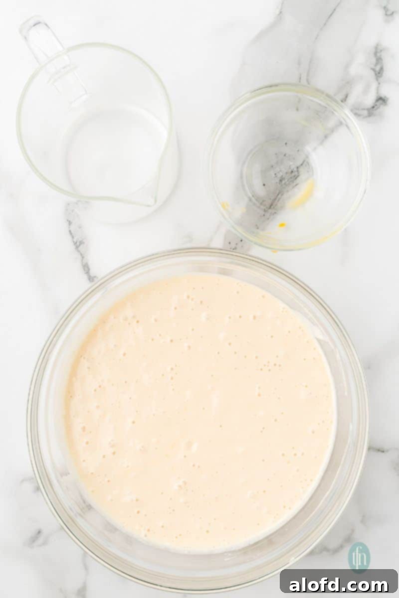 Fluffy Golden Bisquick Waffles 9 A batter mixture in a glass bowl.