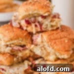 St Patricks Day Feast Ideas 9 Close-up of golden brown, cheesy Baked Reuben Sliders.