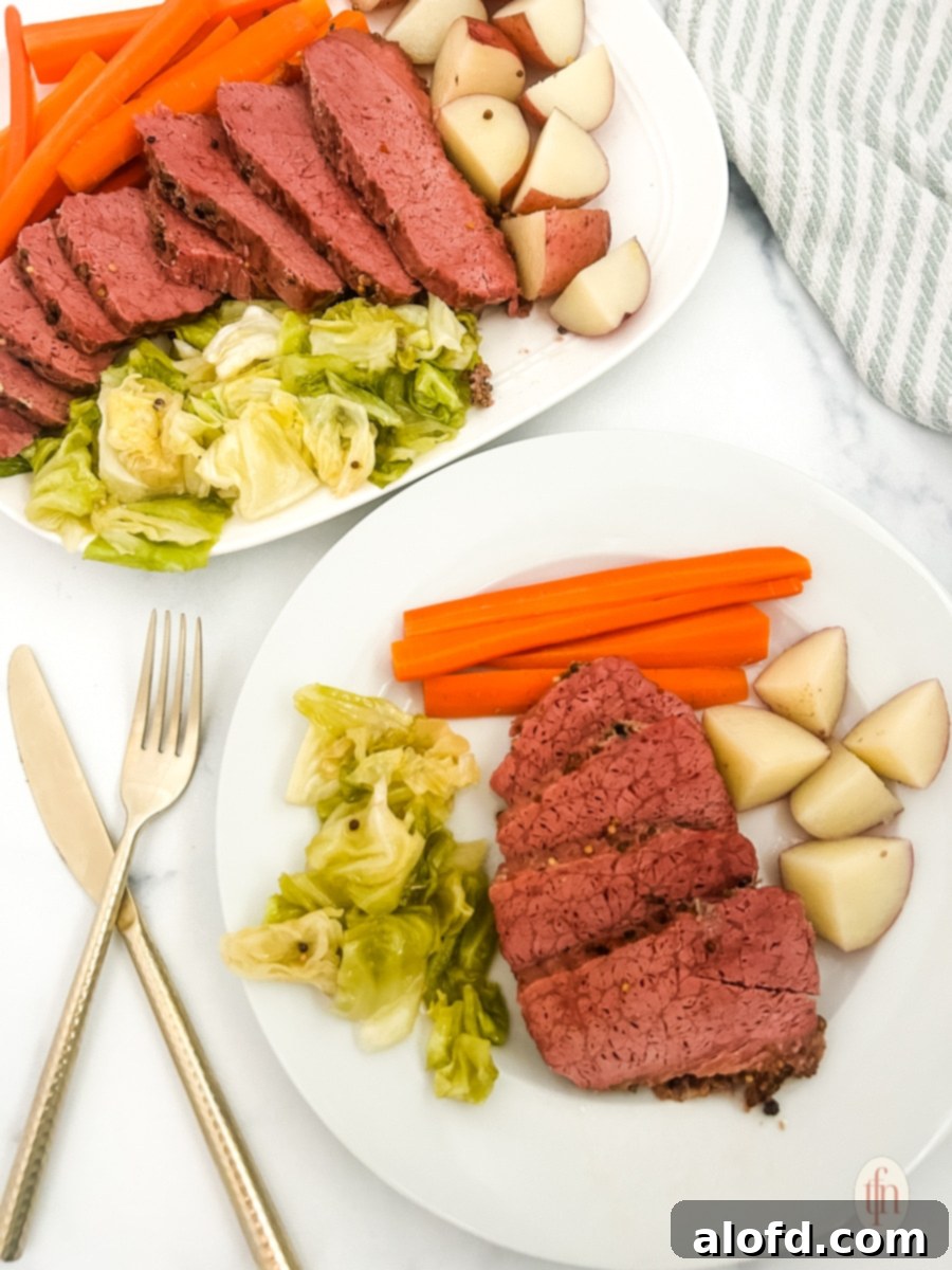 St Patricks Day Feast Ideas 6 Perfectly sliced and plated Dutch oven corned beef with tender vegetables on the side, a classic St. Patrick's Day meal.