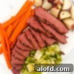 St Patricks Day Feast Ideas 7 Sliced Dutch oven corned beef with tender vegetables on the side.