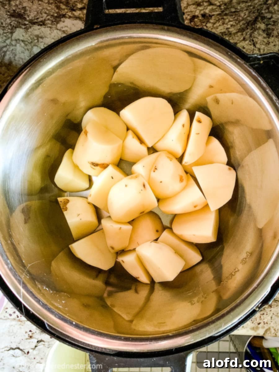 Foolproof Instant Pot No-Drain Mash 3 Peeled and cut potatoes in Instant Pot pressure cooker.