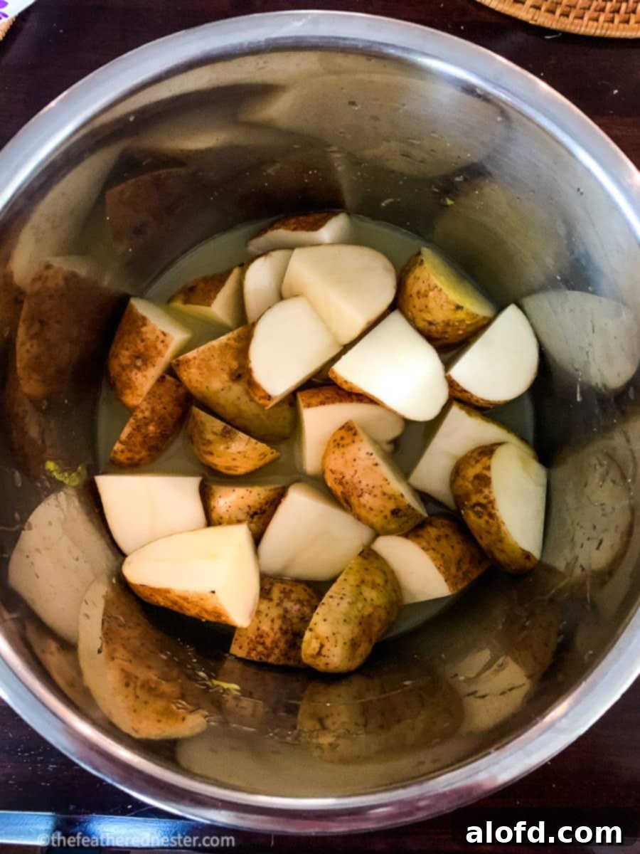 Foolproof Instant Pot No-Drain Mash 6 Unpeeled potatoes cut into wedges, ready to pressure cook.