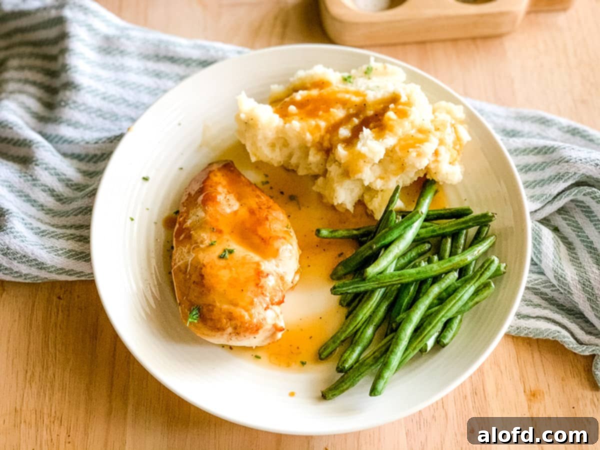 Foolproof Instant Pot No-Drain Mash 10 Plate of mashed potatoes, green beans, and pan seared chicken with gravy.