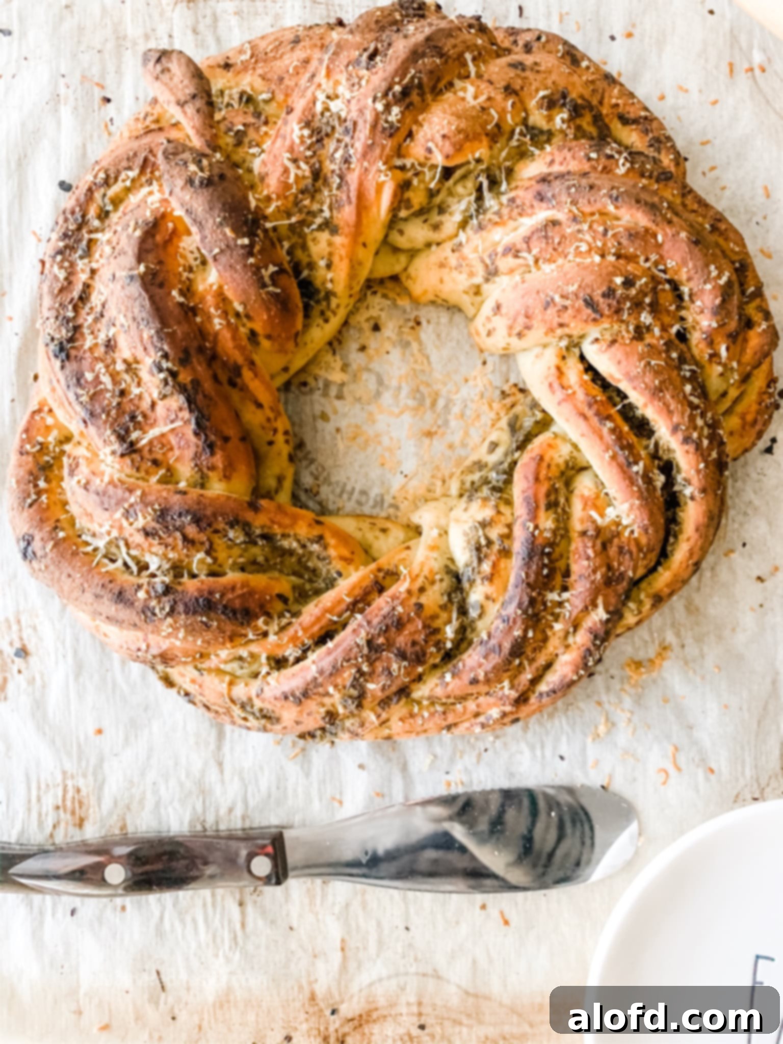 Wreath of twisted bread with Parmesan and pesto sauce baked into it.
