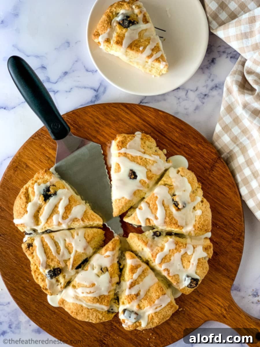 Cut cranberry almond scones on a wooden platter, ready to serve.