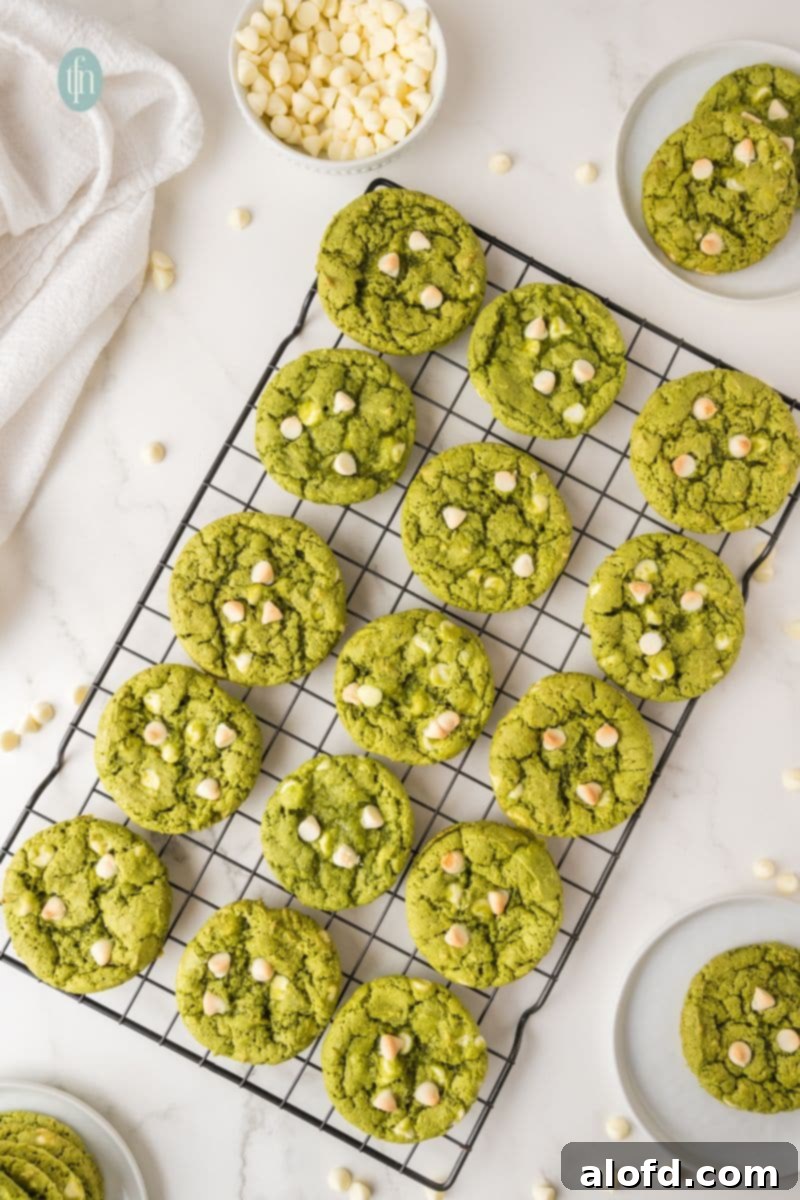 Vibrant Matcha White Chocolate Cookies 13 Baked green matcha white chocolate cookies cooling on a wire rack.