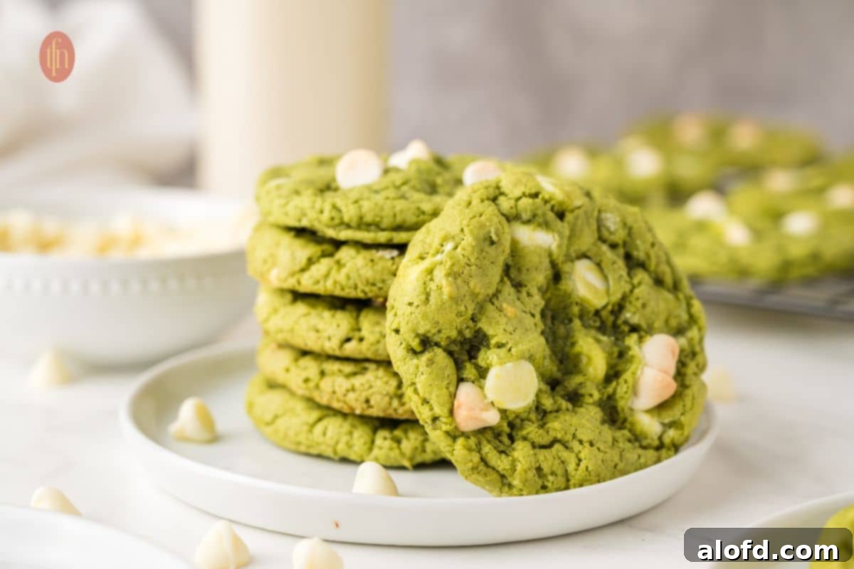 Vibrant Matcha White Chocolate Cookies 16 A large, horizontal image showcasing a plate of beautifully arranged matcha white chocolate cookies, inviting viewers to indulge.