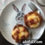 Two cheerful tater tot egg nests playfully arranged on a plate and adorned with an adorable Easter bunny, setting a festive mood.