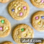 Vibrant spring sugar cookies decorated with pastel M&Ms, capturing the essence of Easter.