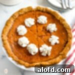 A perfectly baked whole carrot pie resting in its pie plate, ready to be sliced and served.