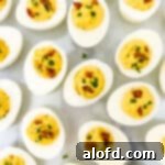 Spicy deviled eggs elegantly arranged and garnished for a festive presentation.