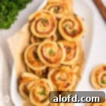 Beautifully arranged ham and cheese pinwheels displayed on an elegant serving platter, ready for guests.