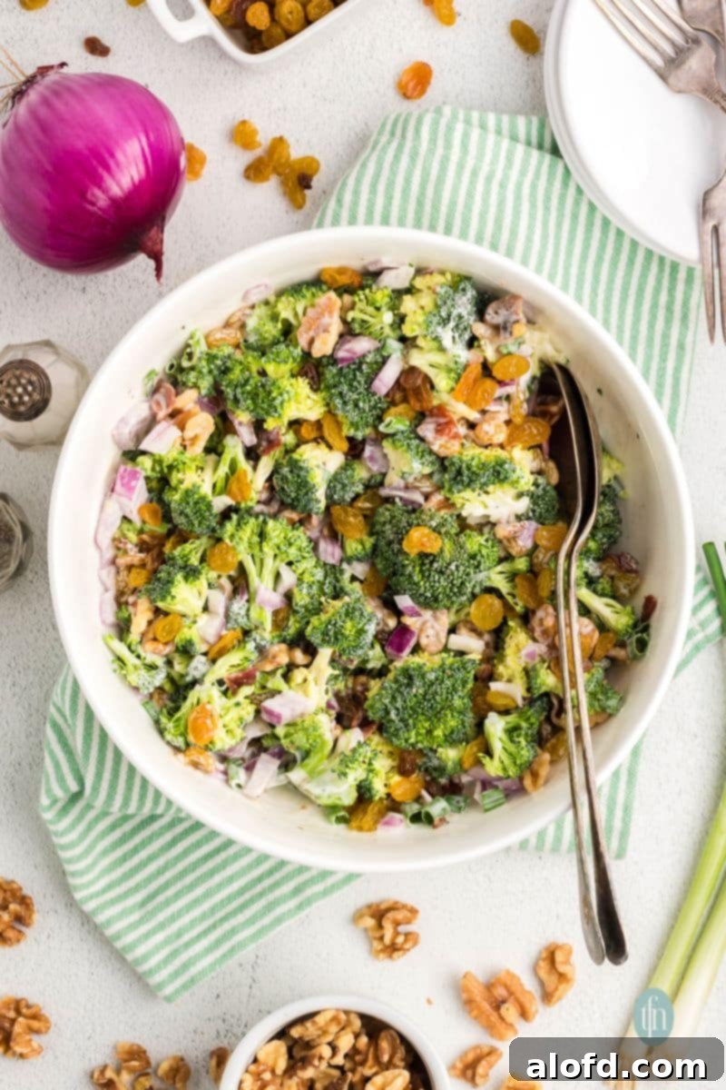 A beautifully presented broccoli raisin salad with bacon in a rustic serving bowl, ready for a gathering.