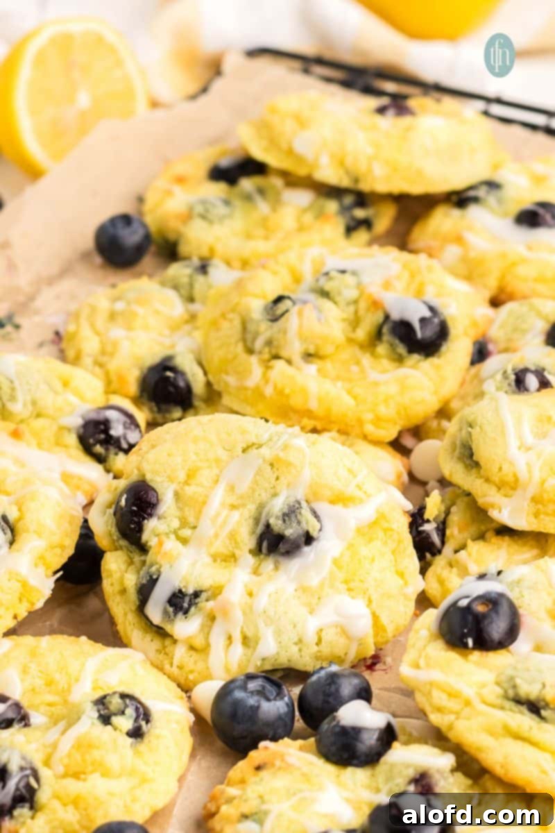 Lemon Blueberry Bliss Bites 21 Freshly baked lemon blueberry cake cookies cooling on a wire rack.