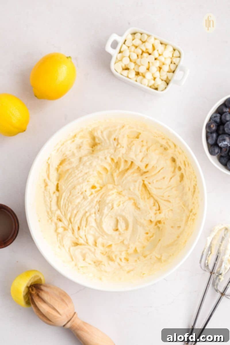Lemon Blueberry Bliss Bites 8 Creamed batter in a white bowl, smooth and ready for dry ingredients.
