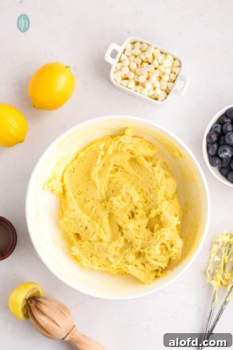 Lemon Blueberry Bliss Bites 10 Partially mixed batter showing cake mix integrating into the wet ingredients.