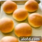 Light and Vibrant Spring Dinners 12 Homemade burger buns on a baking sheet.