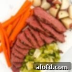 Light and Vibrant Spring Dinners 17 Sliced Dutch oven corned beef with vegetables on the side.