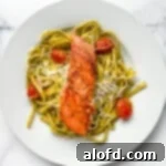 Light and Vibrant Spring Dinners 20 Plated dinner of pesto pasta with salmon filet.