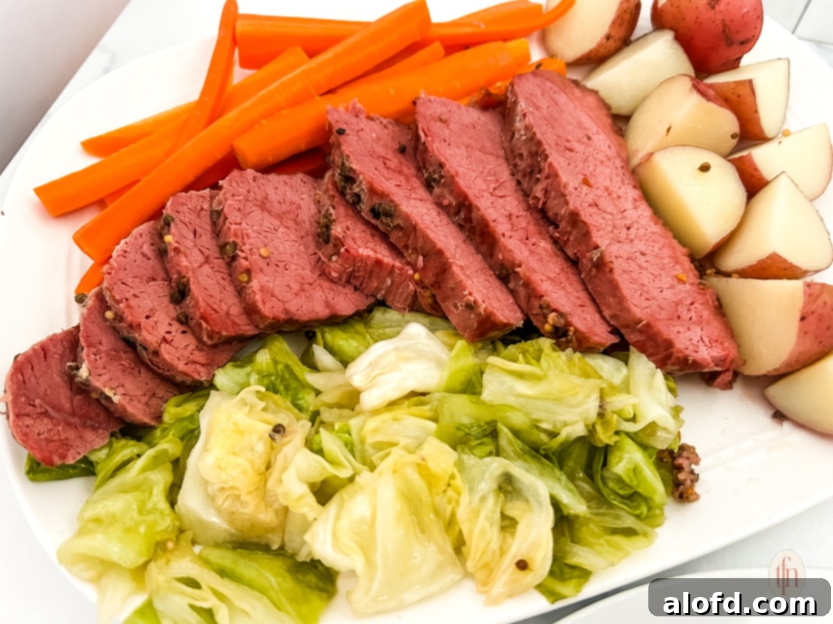 Light and Vibrant Spring Dinners 32 Sliced Dutch oven corned beef with vegetables on the side.