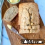 Light and Vibrant Spring Dinners 7 square photo of Bisquick Banana Bread with a bowl of butter and bread knife on top of a wooden board.