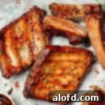 Baby back pork ribs slathered in BBQ sauce.