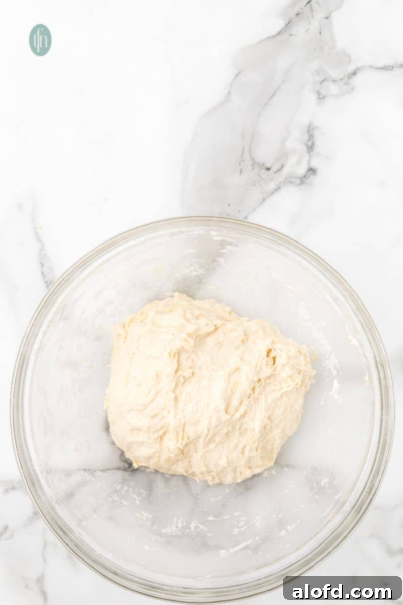A glass bowl with dough.