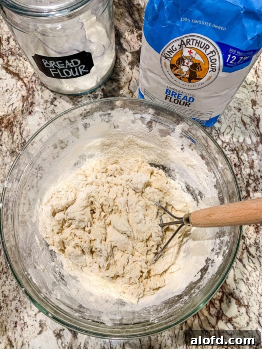 A glass bowl with shaggy bread dough.